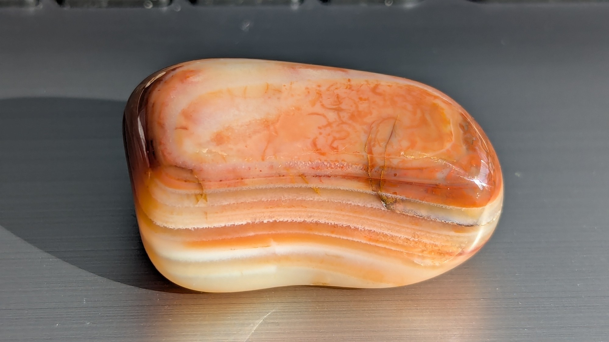 Tumbled stone with orange and cream bands stacked like sandstone layers